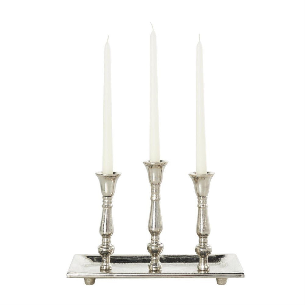 Three silver candlesticks on a rectangular tray.