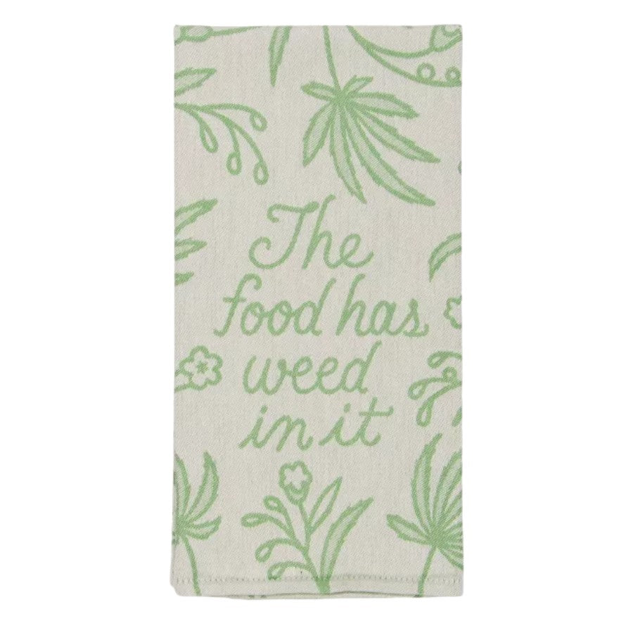 Kitchen towel with "The food has weed in it" printed in green.