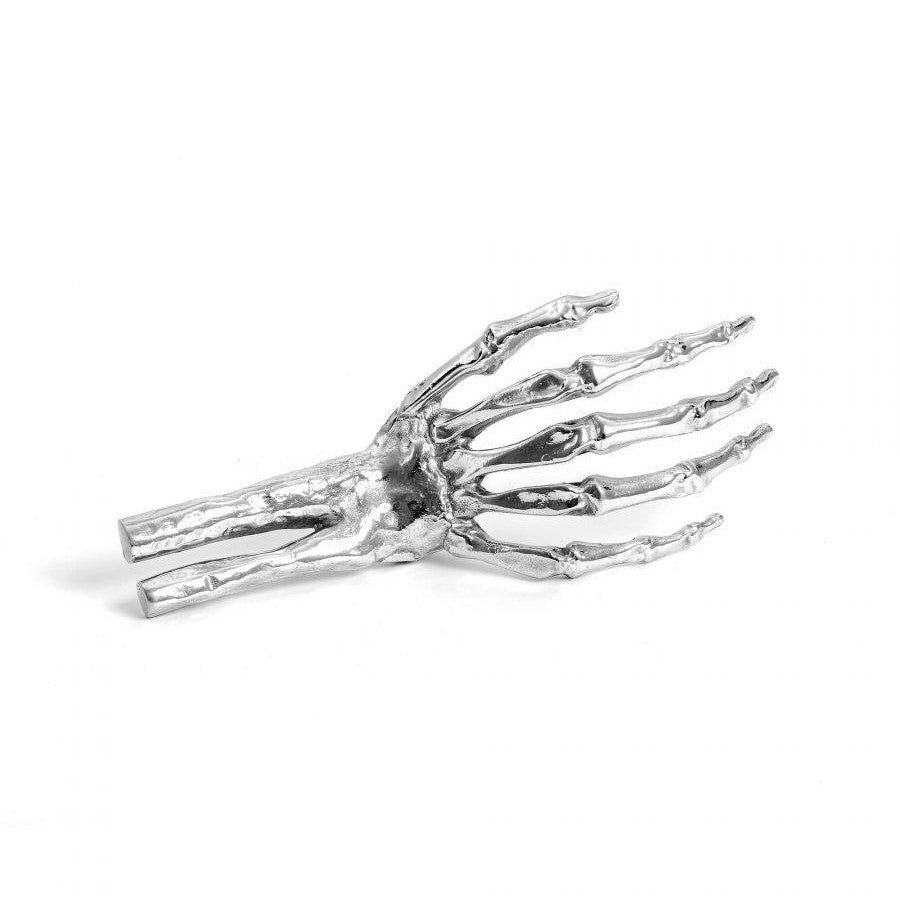 Silver skeletal hand sculpture on a plain background.
