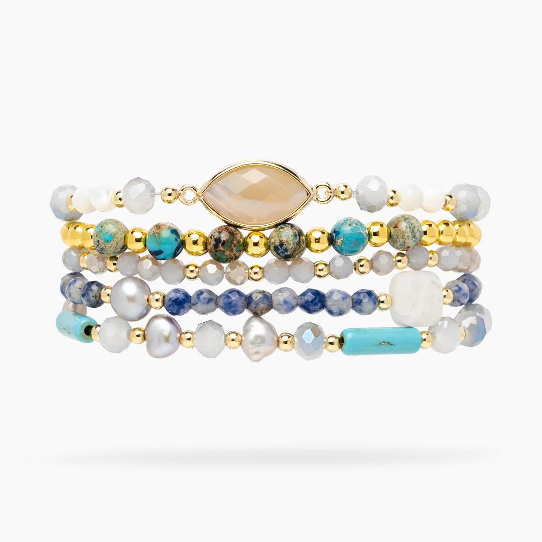 Stack of colorful beaded bracelets with gold accents.