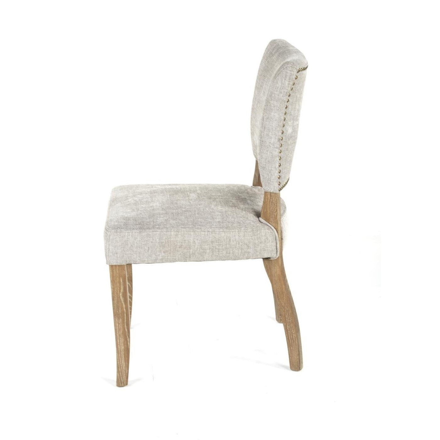 Beige cushioned chair with wood legs and nailhead trim.