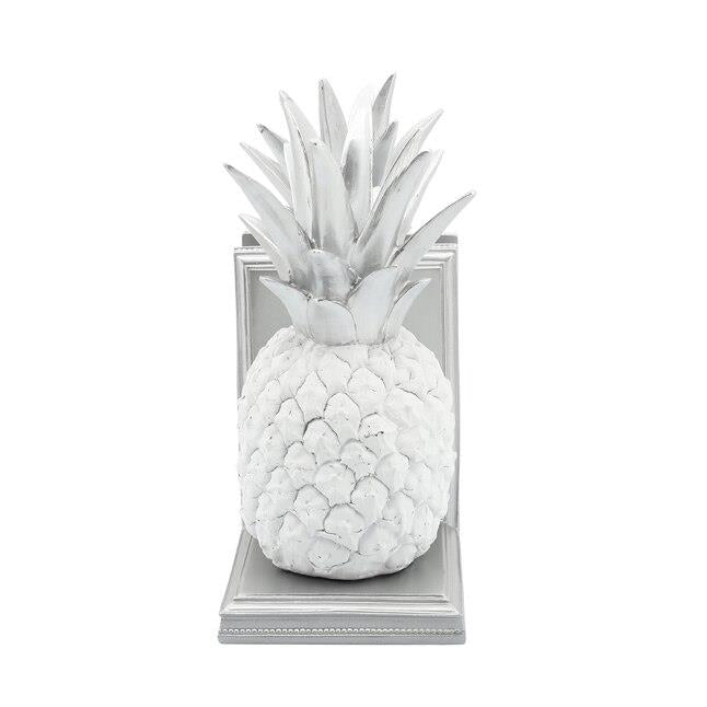 White pineapple decor on a gray bookend.