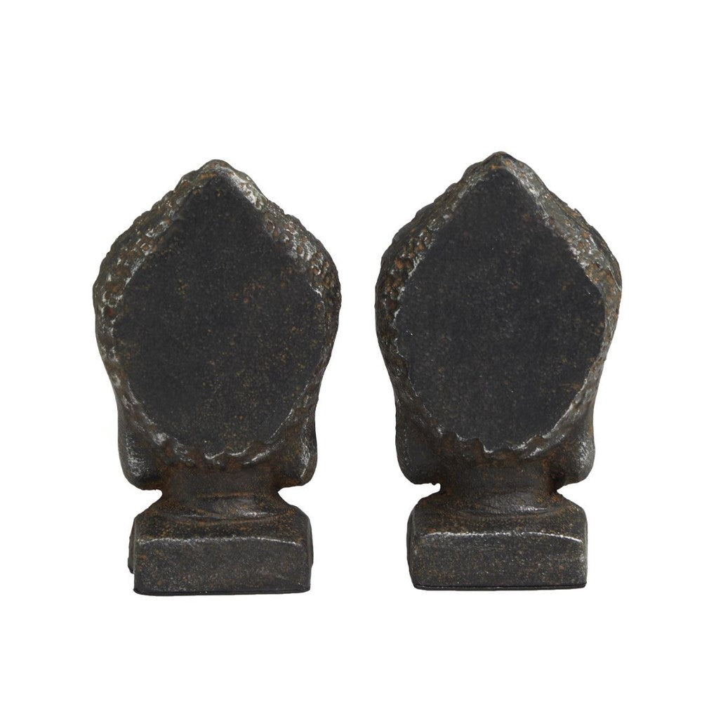 Two dark, leaf-shaped figures on square bases, positioned side by side.