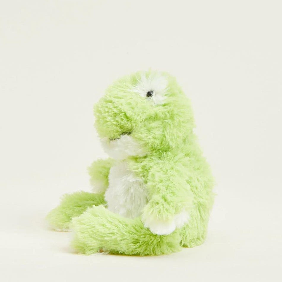 Fluffy green and white dinosaur plush toy against a plain background.