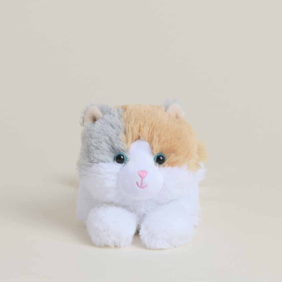 Plush toy cat with gray, orange, and white fur sitting on a beige background.