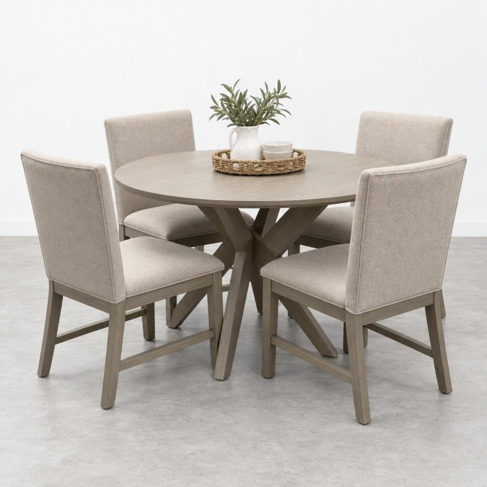 Round table with beige chairs and a plant centerpiece.