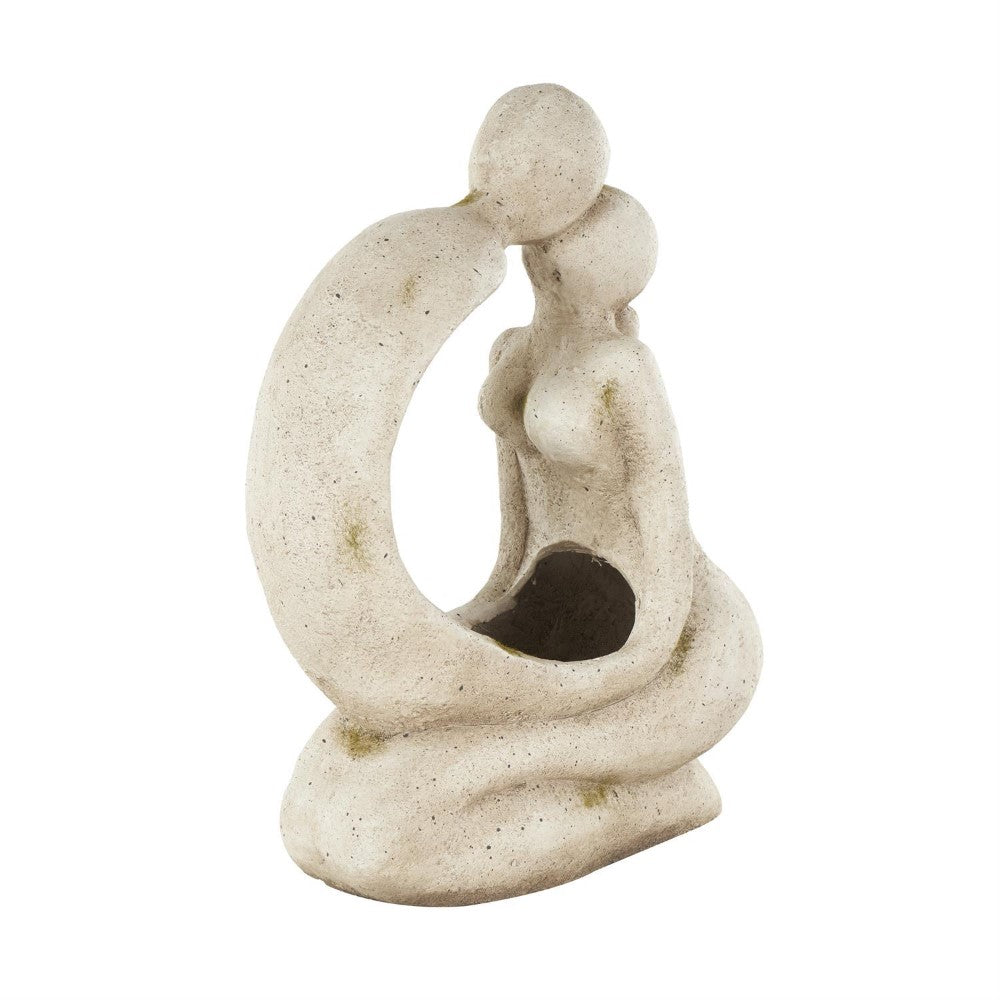Abstract stone-like sculpture of two embracing figures.