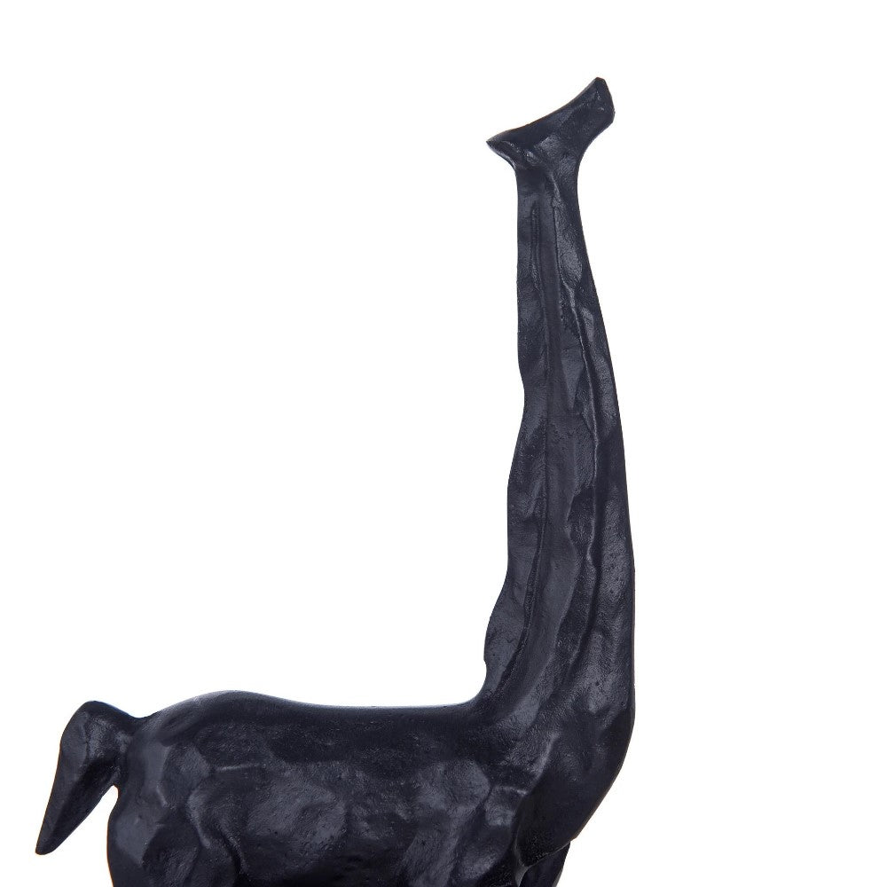 Abstract sculpture of a giraffe-like figure in black.