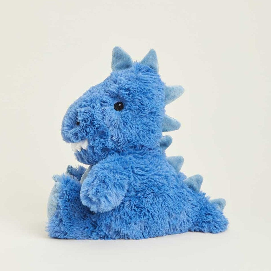 Fluffy blue dinosaur plush toy with spikes, sitting upright.