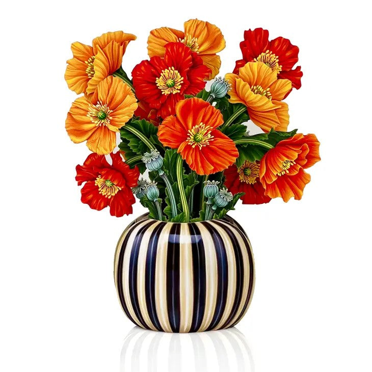 Vibrant red and orange flowers in a striped vase.