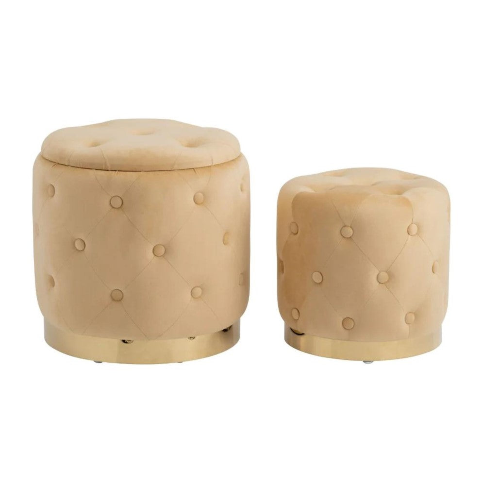 Two round, tufted beige ottomans with gold bases.