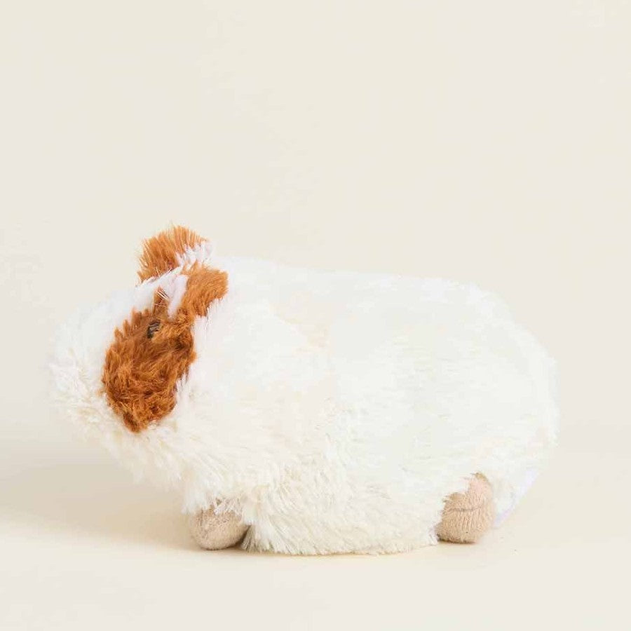 Fluffy white and brown guinea pig plush toy.