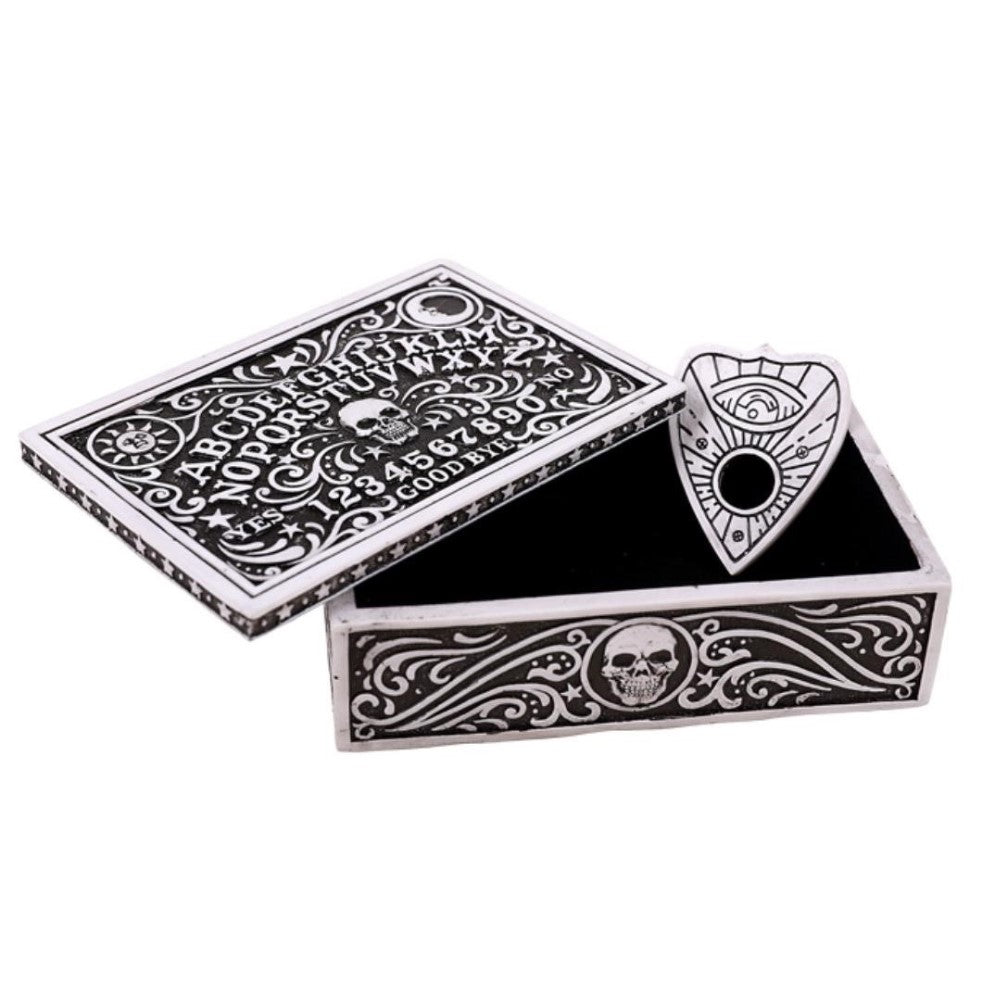 Decorative black and white Ouija board with planchette, featuring skull designs.