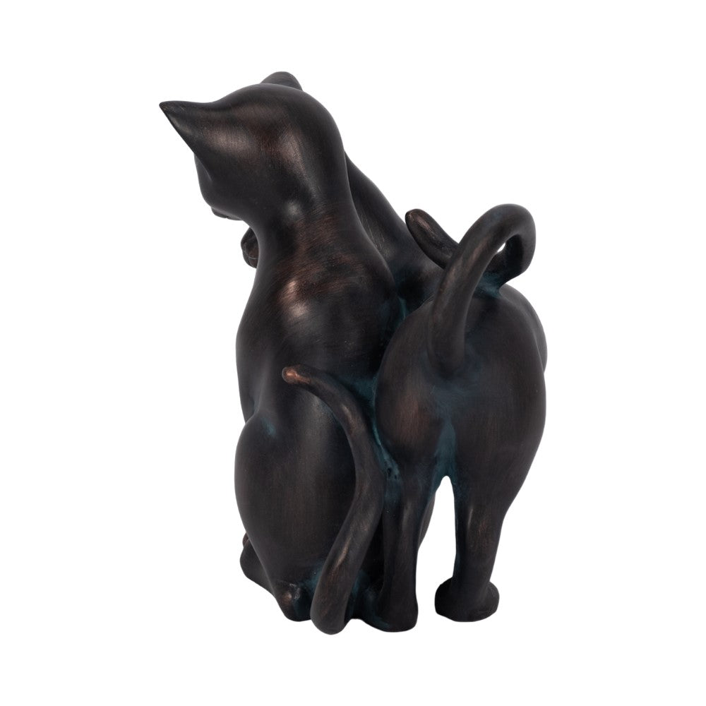 Two bronze cat sculptures sitting back-to-back with tails entwined.