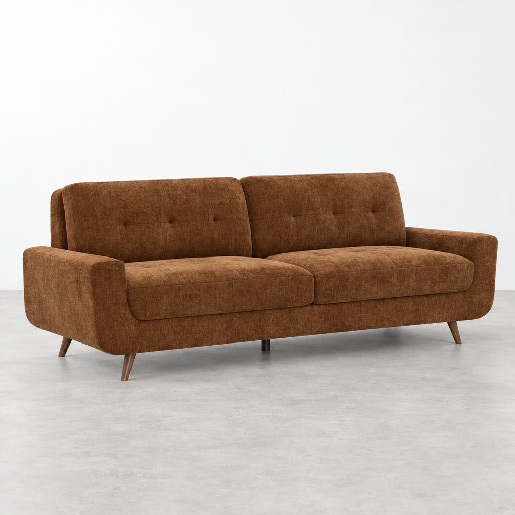 Brown mid-century modern sofa with wooden legs on a gray floor.