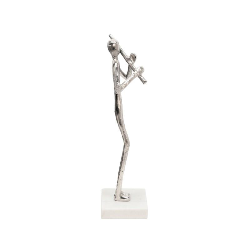Silver sculpture of a person playing a flute on a white base.