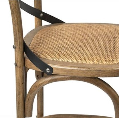 Wooden chair with caned seat and black metal supports.