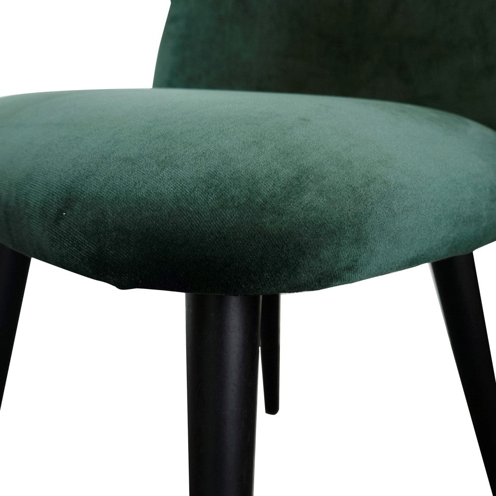 Green velvet chair with dark legs.