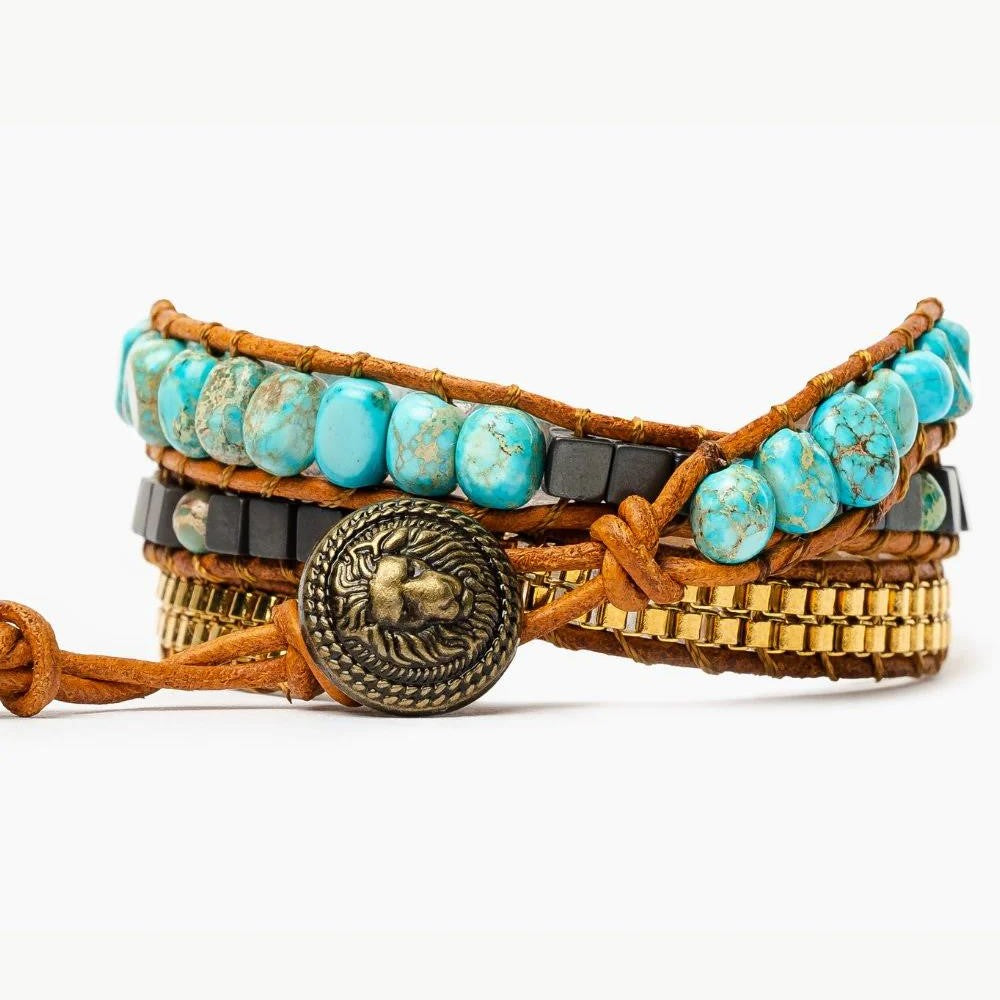 Braided bracelet with turquoise beads and lion design clasp.