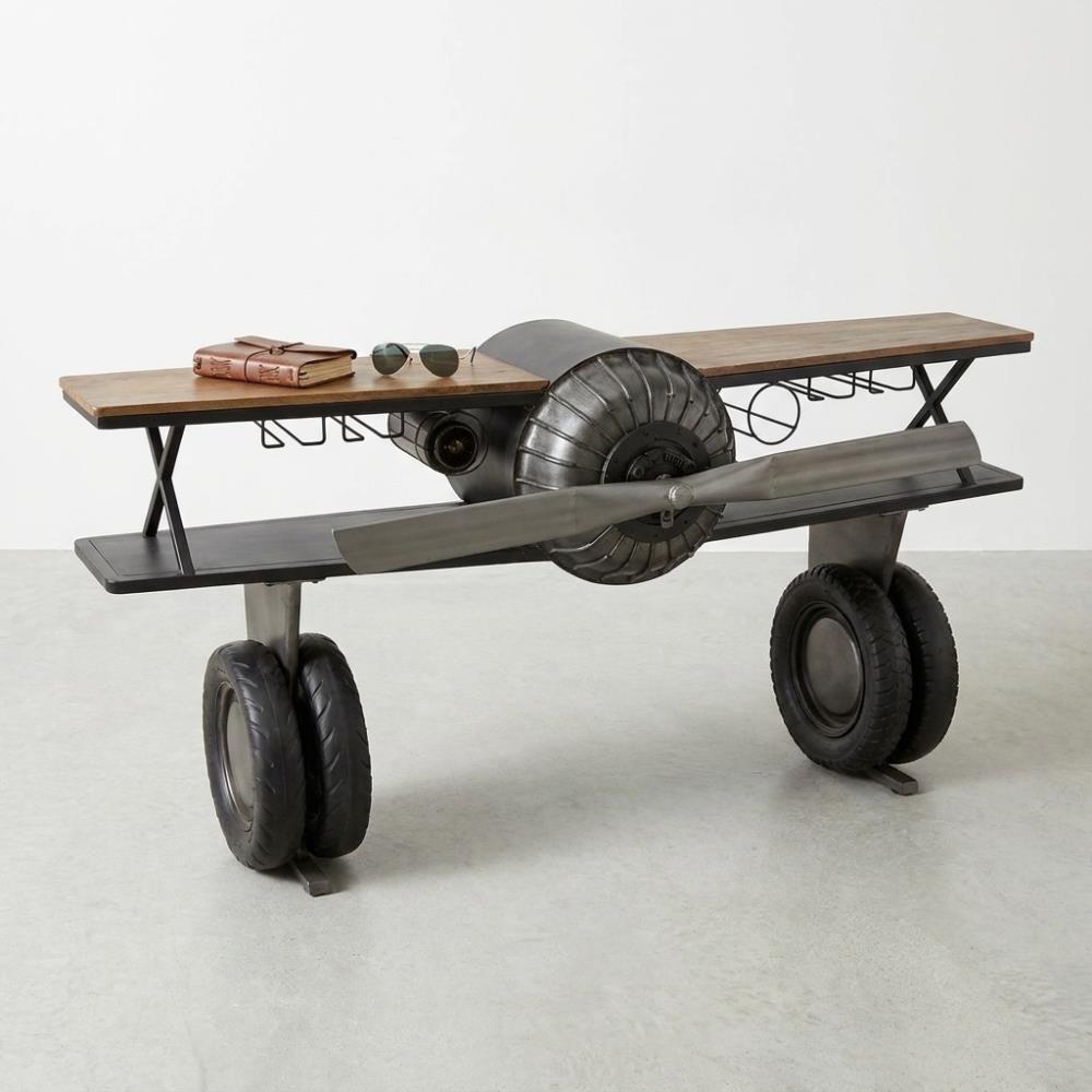 Airplane-themed desk with wheels and propeller, sunglasses, and a book on top.
