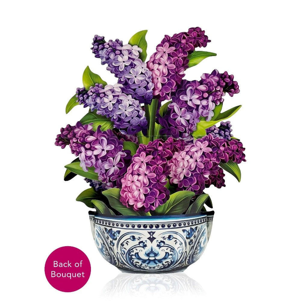Purple and pink flowers in a decorative vase.