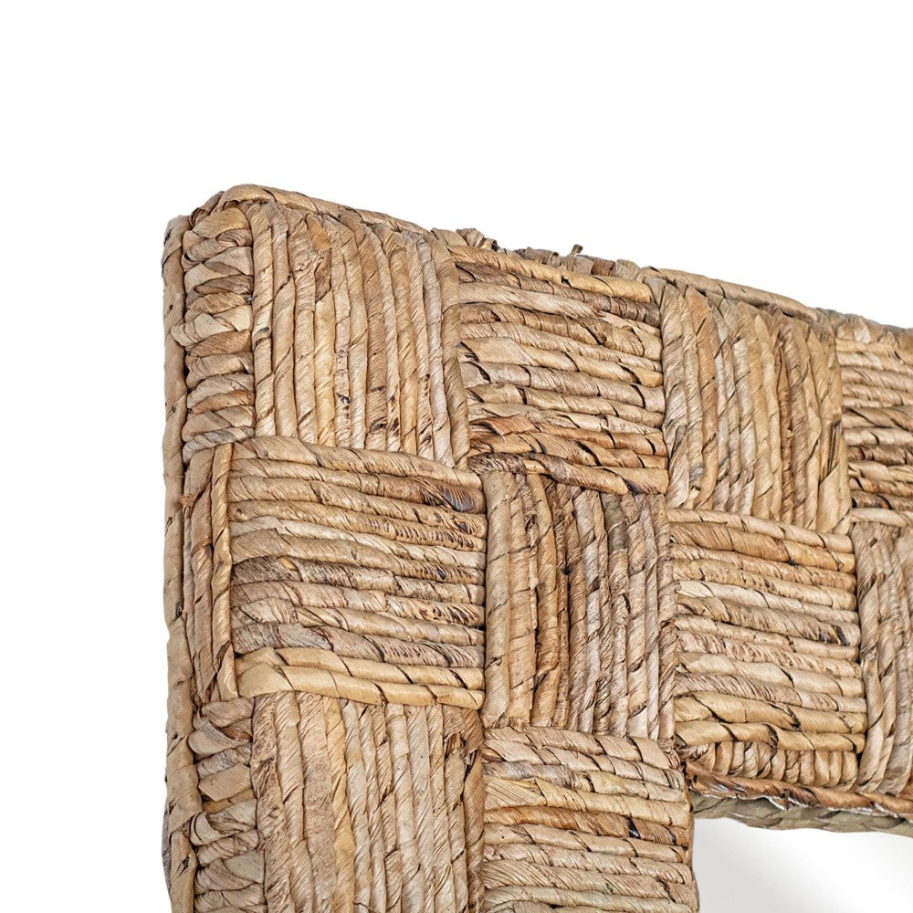 Woven wicker pattern in a wooden frame corner.