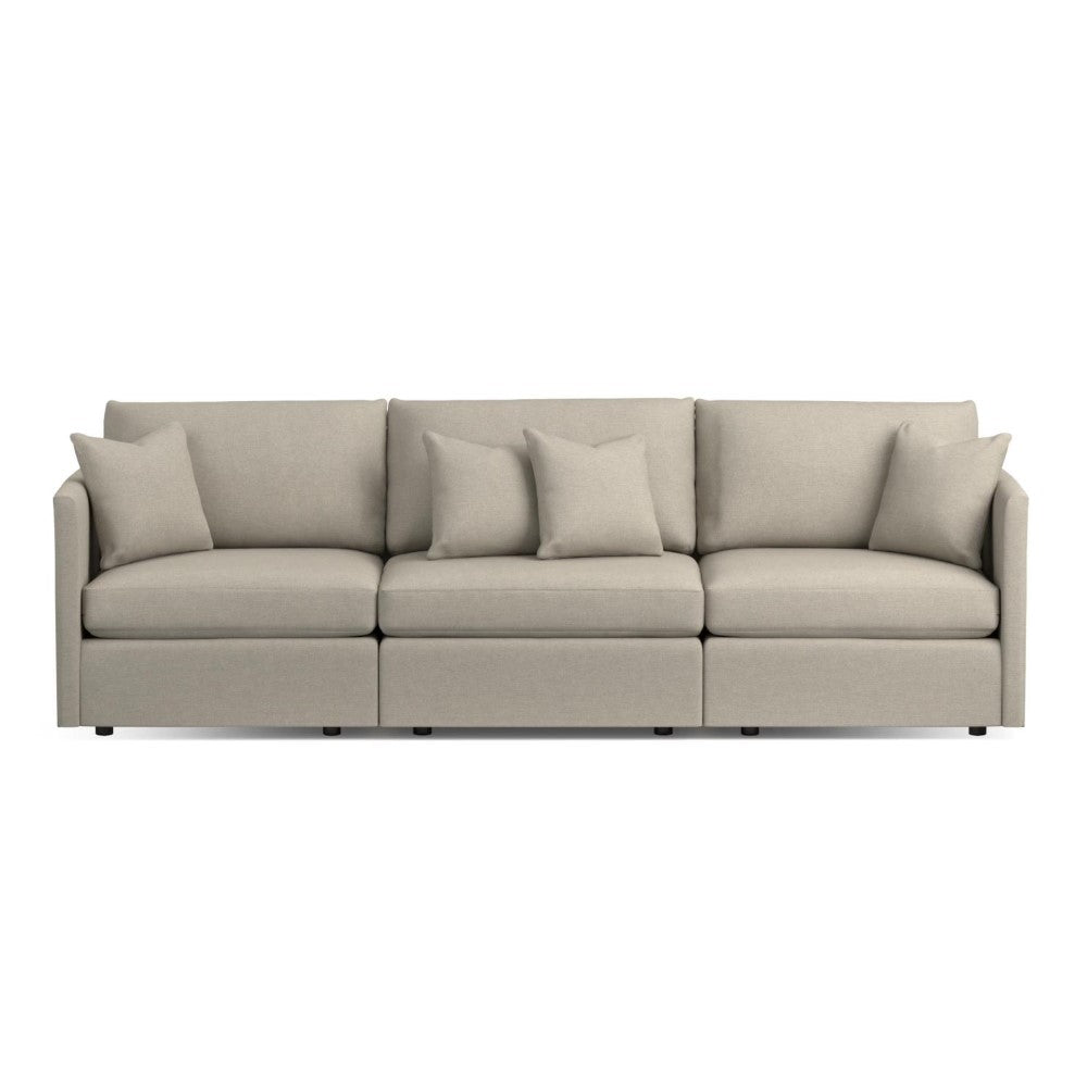 Modern beige sofa with matching cushions on a white background.