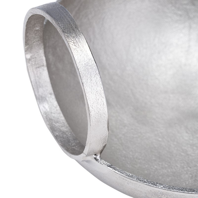 Close-up of a metallic round object with a textured handle.