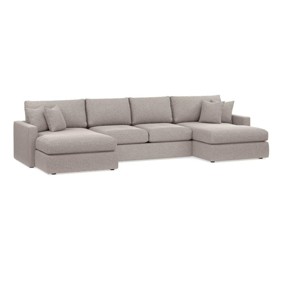 Large grey sectional sofa with plush cushions and chaise lounges on each end.