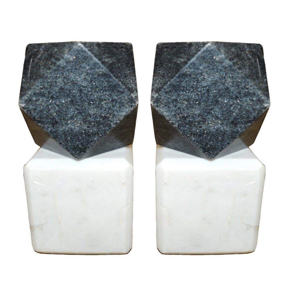 Two geometric stone sculptures with dark tops and white bases.