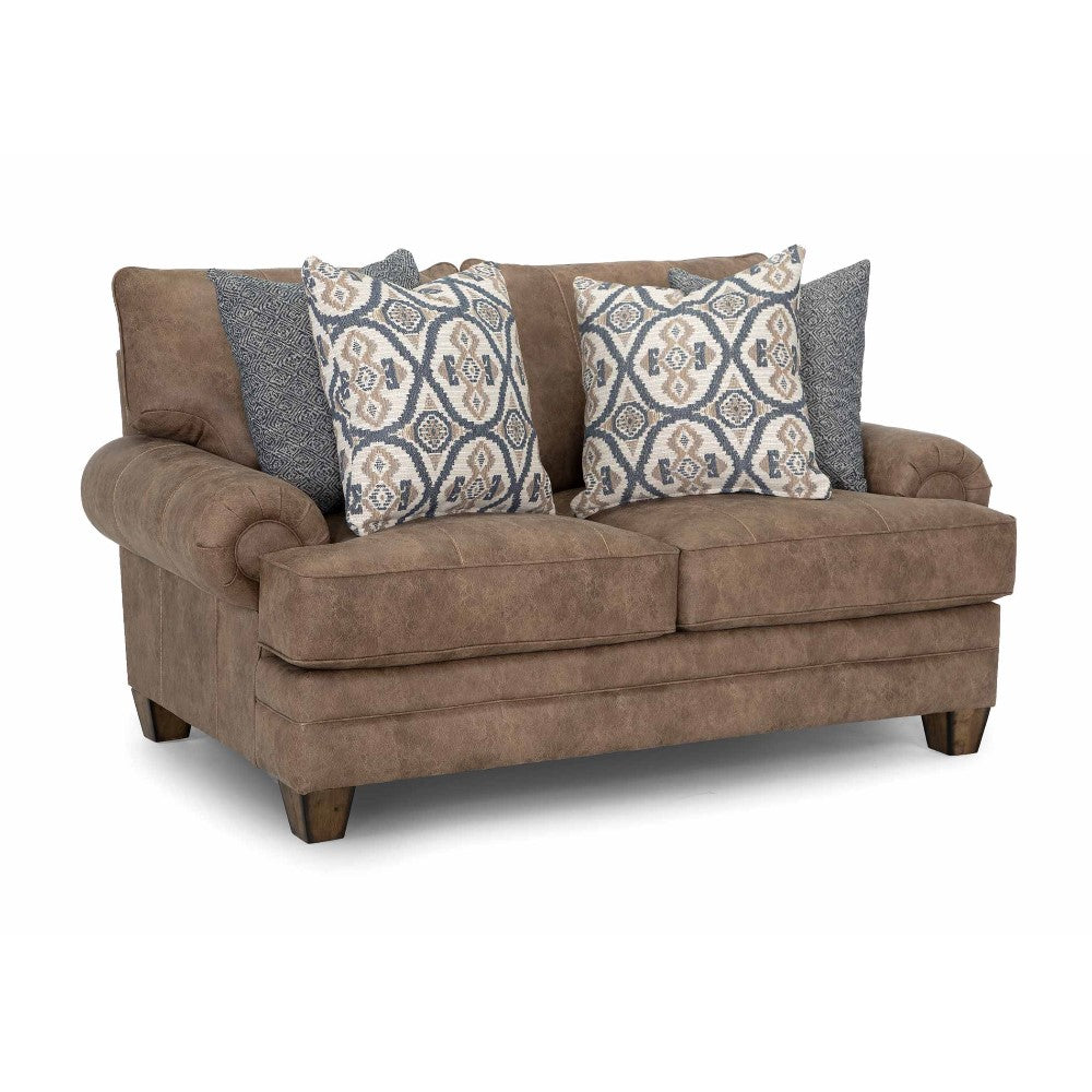 Brown couch with patterned and solid cushions on white background.