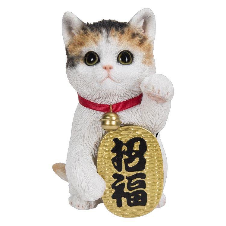 Cute cat figurine with raised paw and a gold sign.