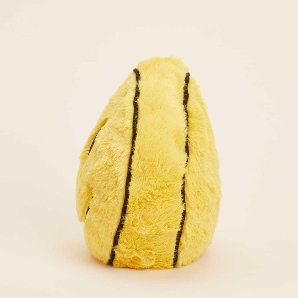Yellow plush banana with black stitching on a light background.