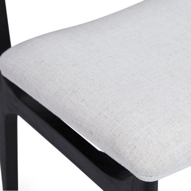 Black wooden chair with a white upholstered seat.