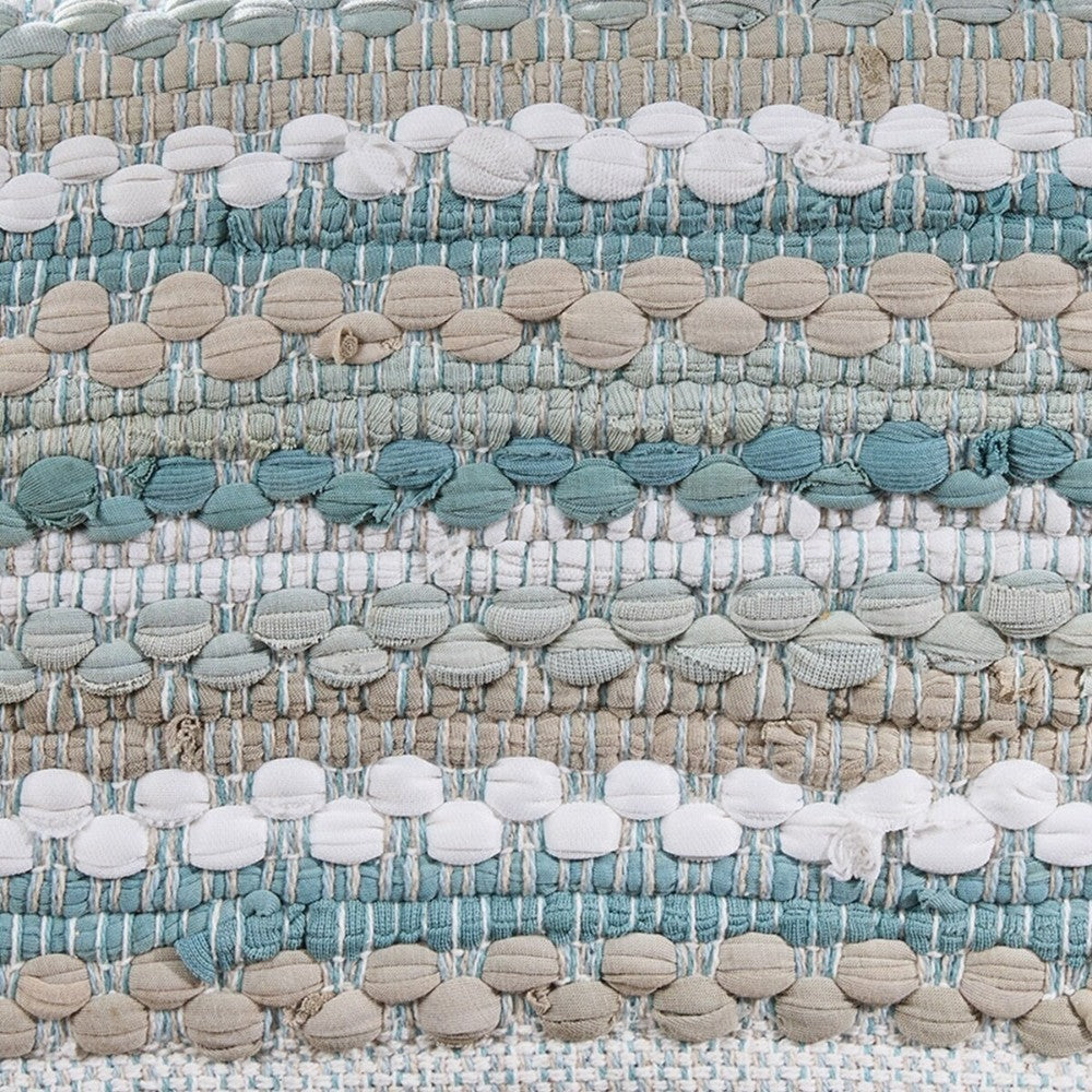 Textured woven fabric in earthy tones and muted blues.