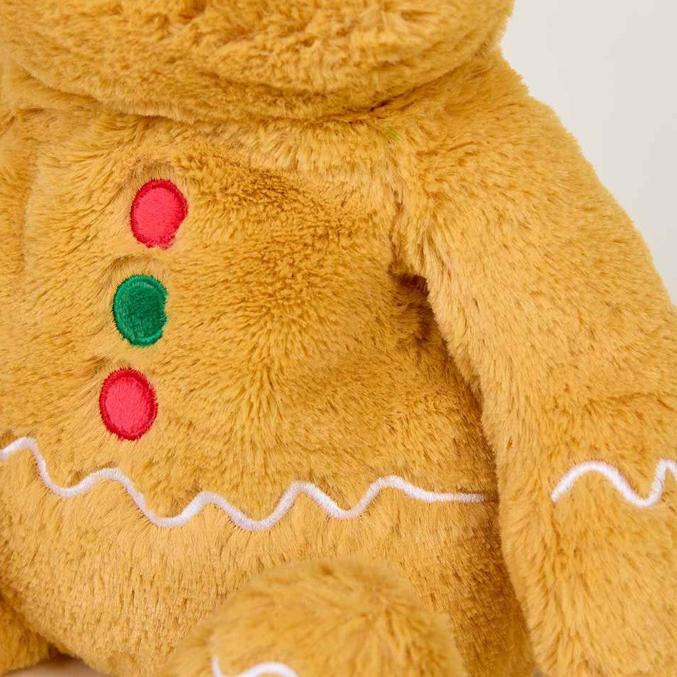 Fuzzy gingerbread plush with colorful buttons and wavy white accents.