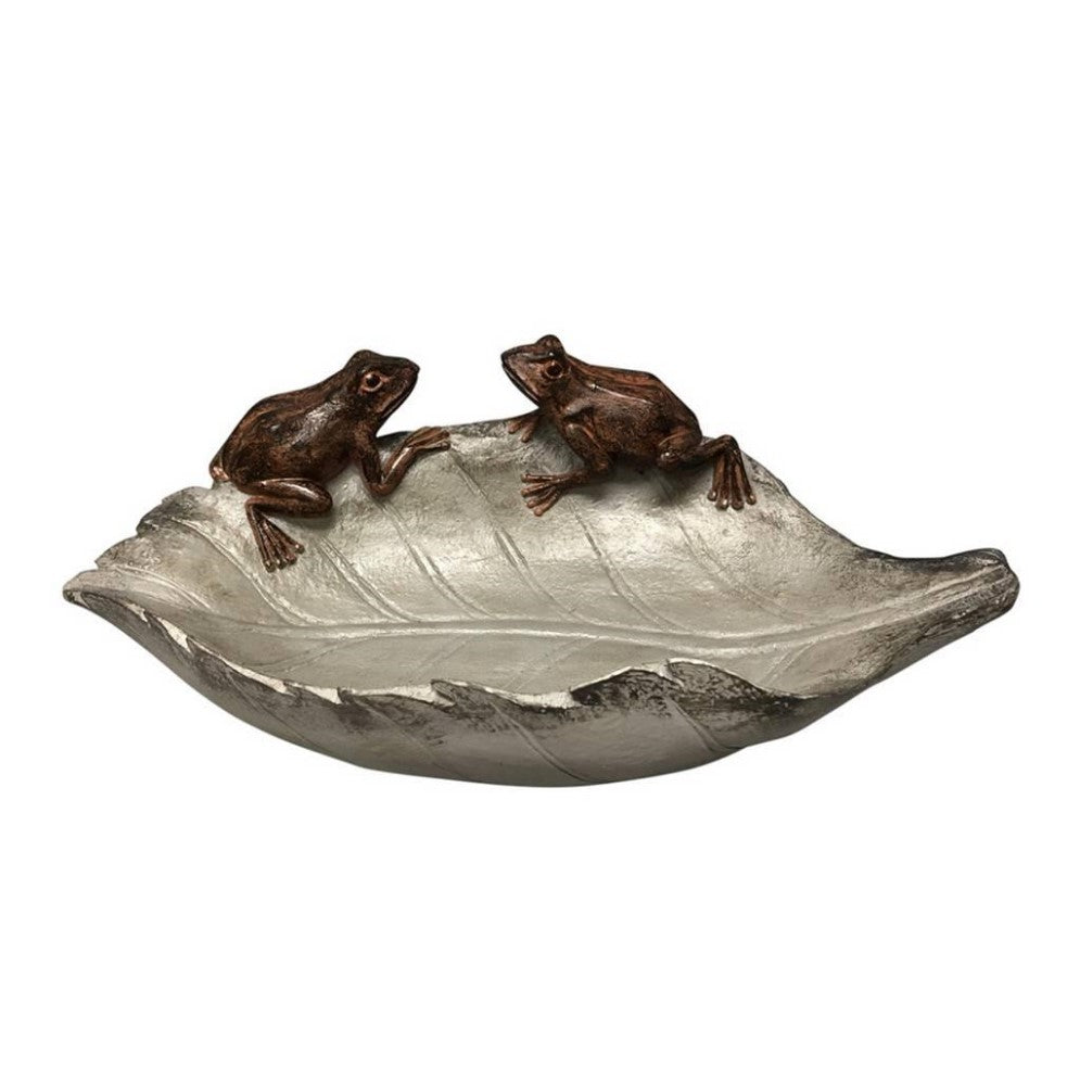 Two frogs on a leaf-shaped sculpture.