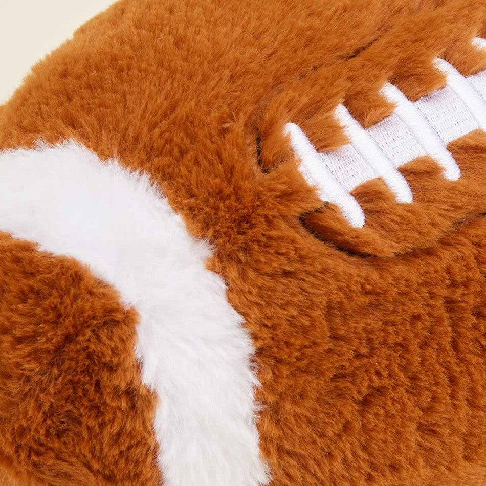 Furry football toy with white laces.