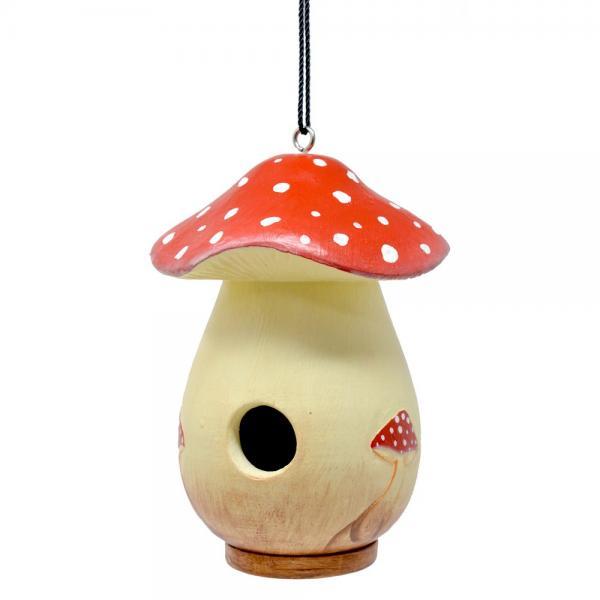 Mushroom-shaped birdhouse with red cap and white spots.