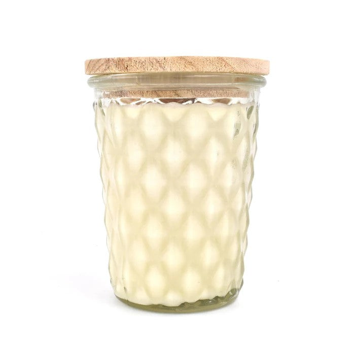 Textured glass jar with a wooden lid, filled with wax.