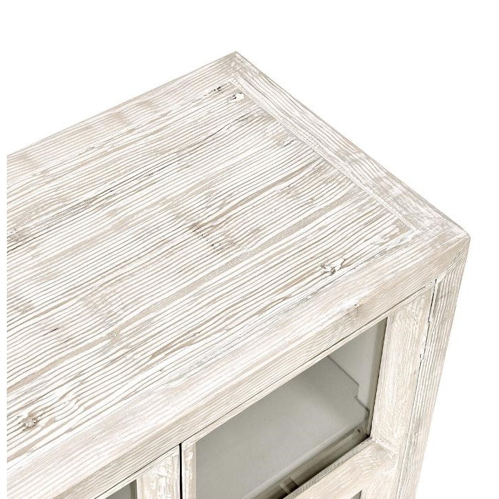 Whitewashed wooden cabinet with glass doors, viewed from above.