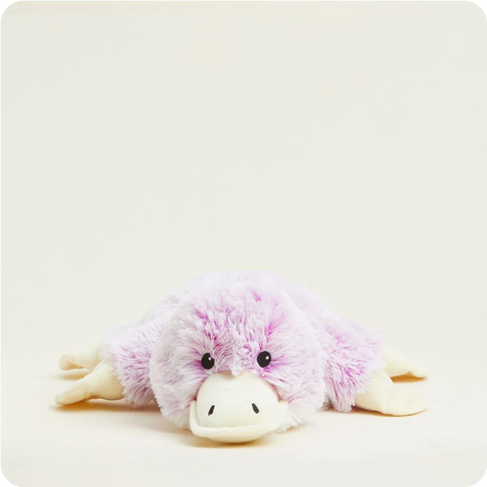 Fluffy purple platypus plush toy on a white background.