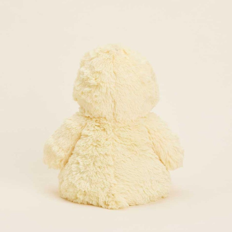 Fluffy beige teddy bear facing away.