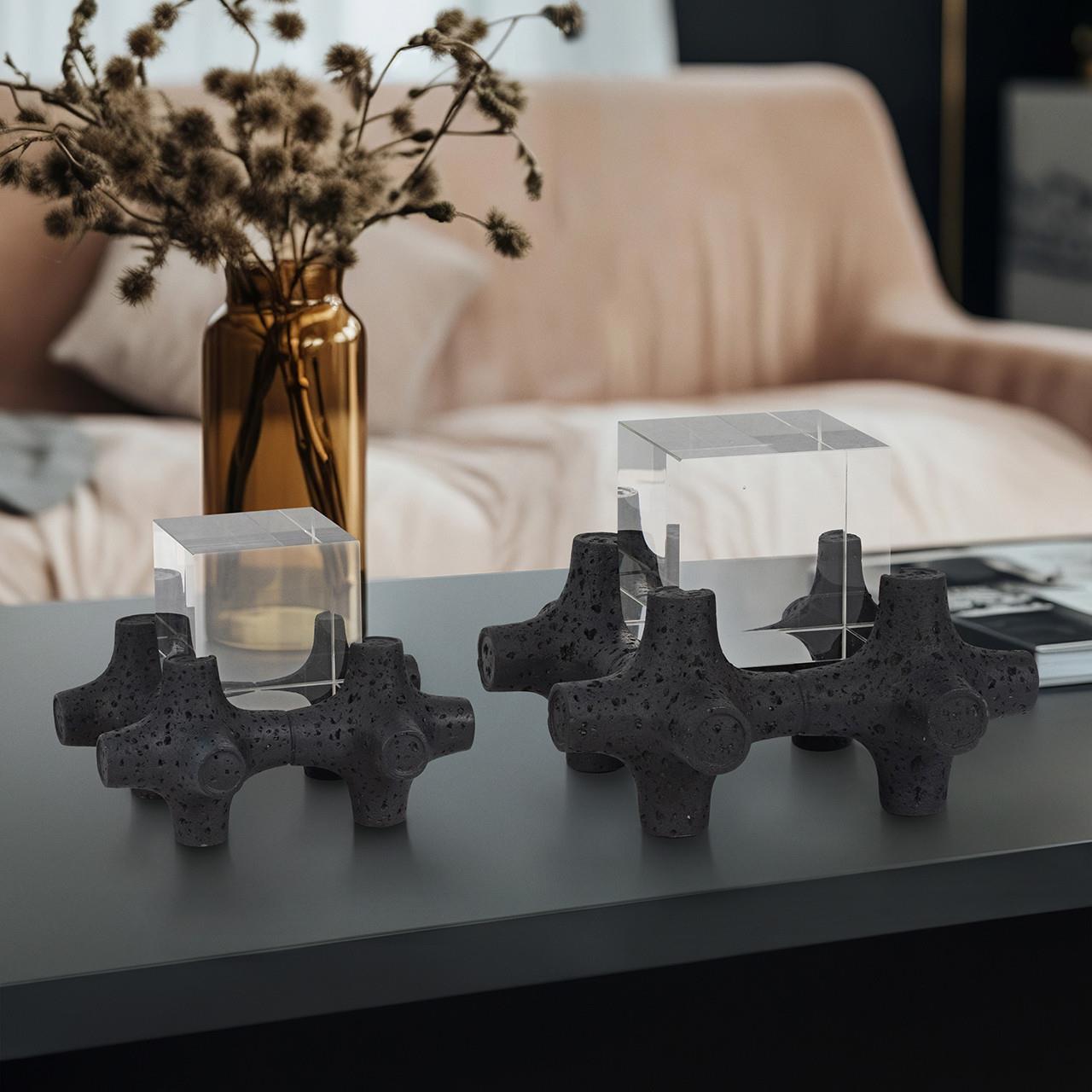 Modern decor with geometric sculptures and glass cubes on a table.