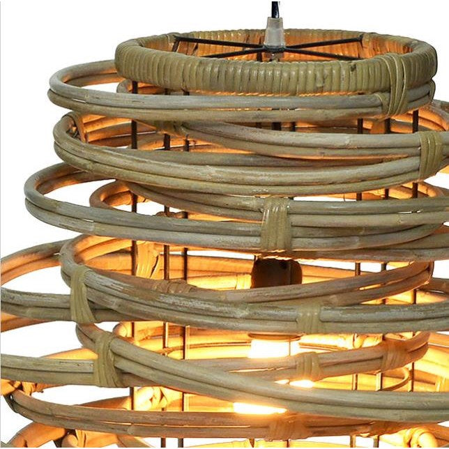 Woven rattan lamp shade with warm glowing light inside.