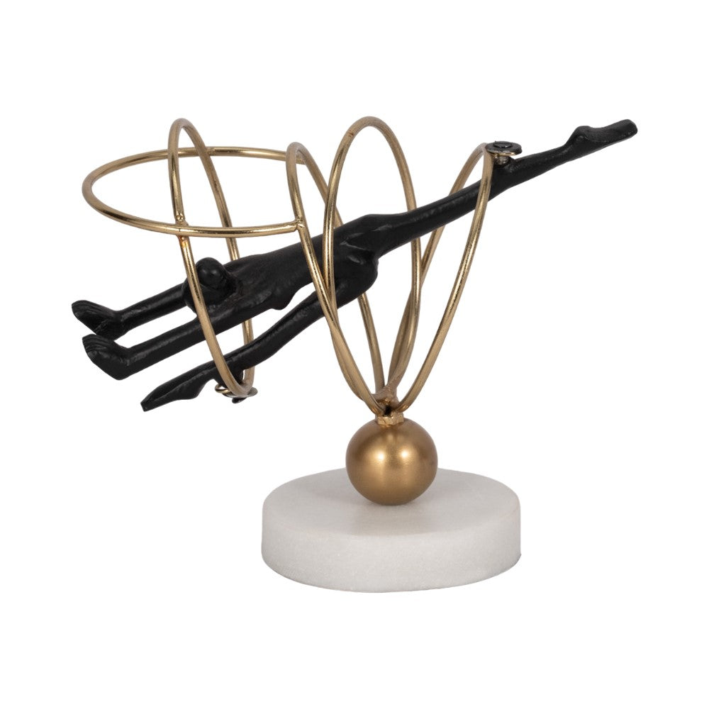 Abstract sculpture of a figure with gold rings on a white base.