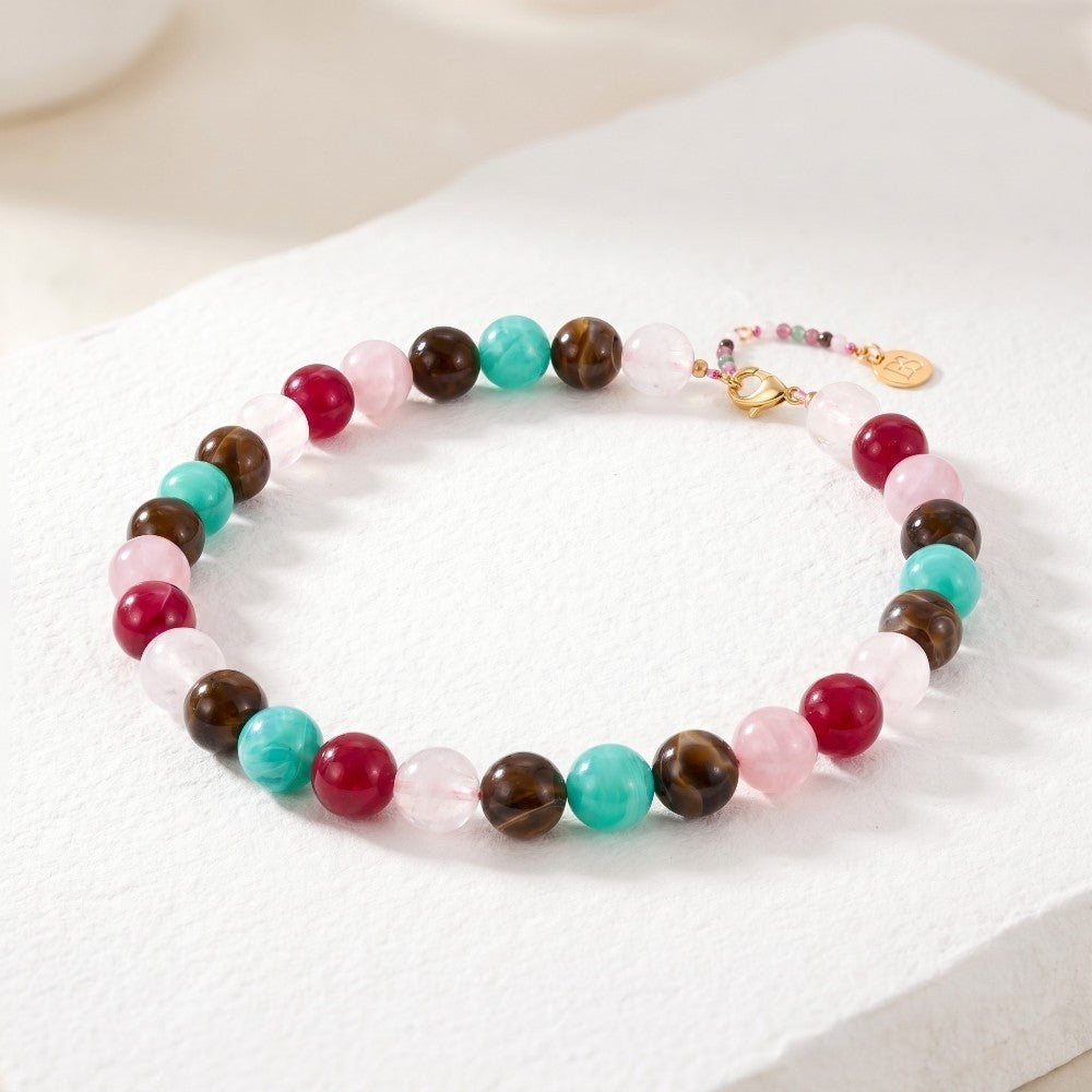 Colorful beaded bracelet on a white surface.