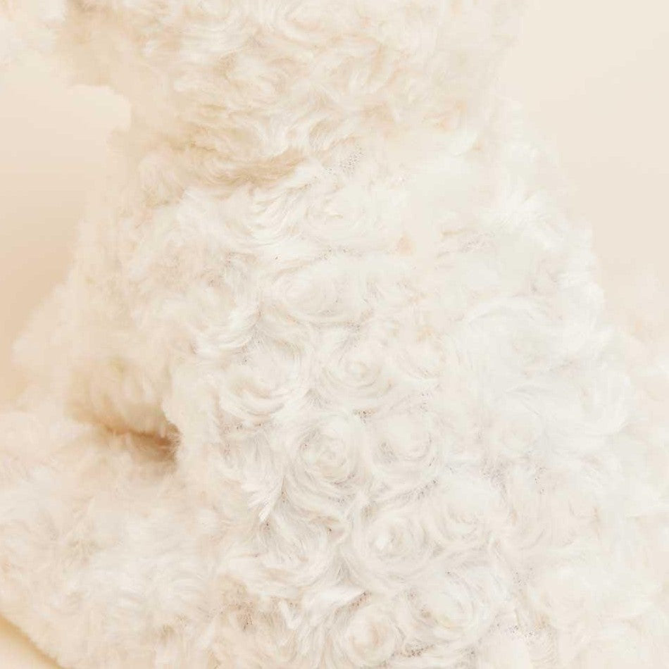 Close-up of fluffy white textured material, swirled pattern.