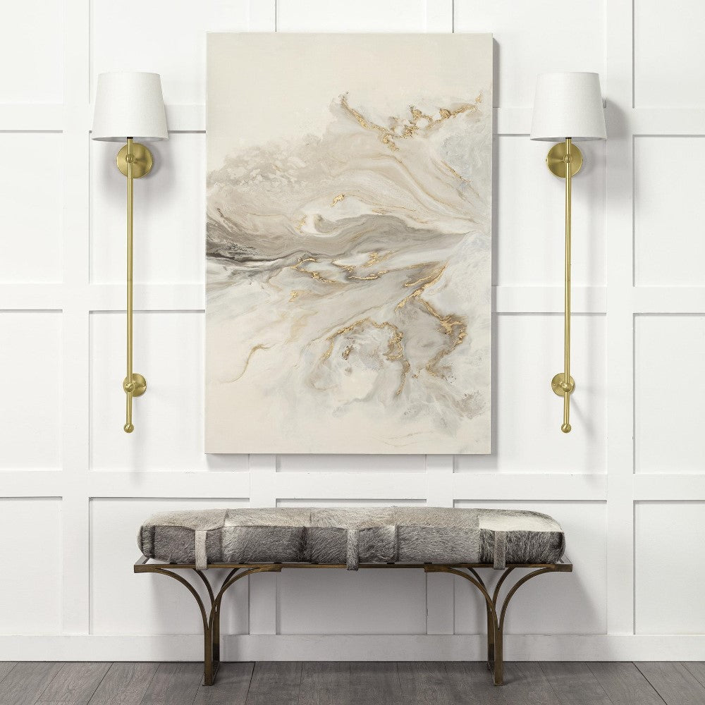 Elegant room with abstract art, wall sconces, and a cushioned bench.