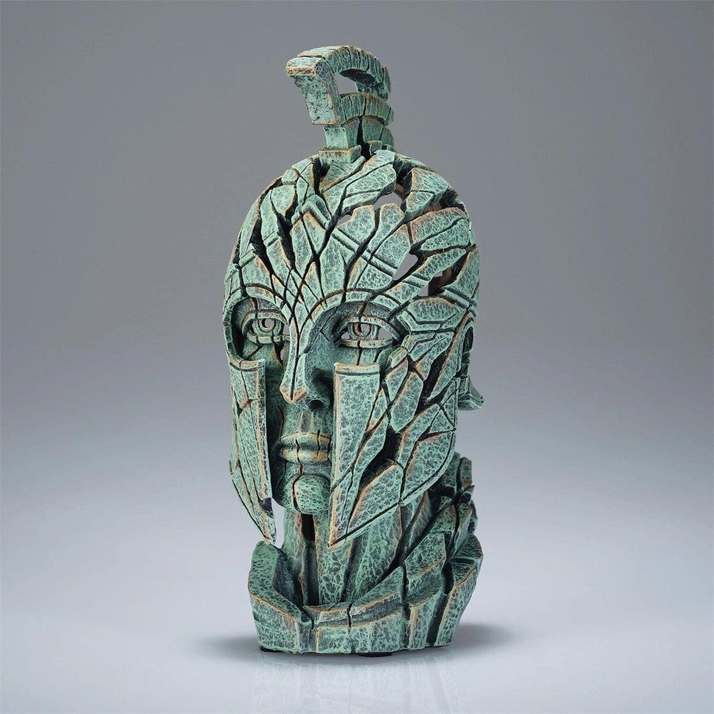 Cracked warrior helmet sculpture in shades of green.